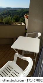 high angle view of empty chairs on balcony of building in sunlight