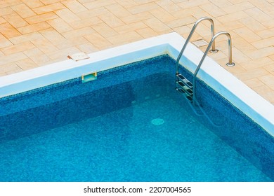 High Angle View Of Empty Outdoor Swimming Pool With Clean Blue Water On Summer Day