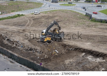 High Angle View of Excavator Loading Dumper Truck
