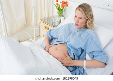 High Angle View Of Expectant Woman Suffering From Labor Pains In Hospital Ward