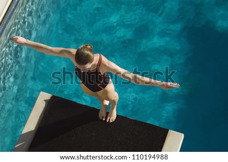 High angle view of a female diver ready to dive while standing at the edge of the springboard