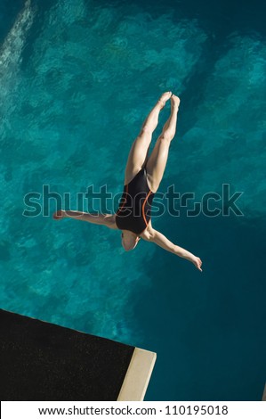 High angle view of a female diver in midair diving