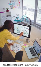 High Angle View Of Female Graphic Designer Working In Creative Office