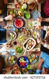 High Angle View Of Festive Table And People Eating