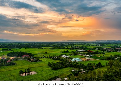 High angle view of fields and villages at sunset.