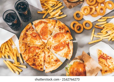 High Angle View Of Friends Eating Burger And French Fries At Table In Cafe.