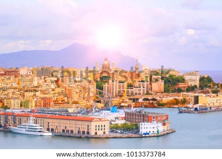 High angle view of Genoa (Genova) city with sea view and yachts under the bright sun in natural background.