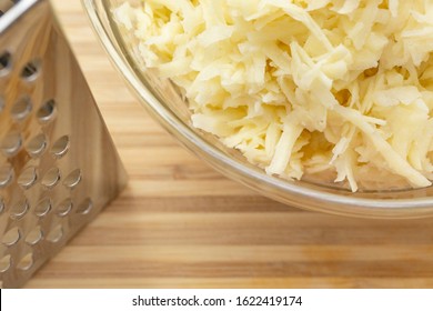 High Angle View Of Grated Potatoes In Bowl On Counter During Food Prep