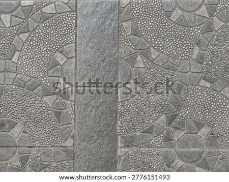 High angle view of grey stone tiles pattern on the sidewalk pavement.