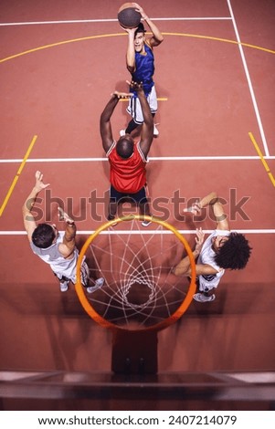 High angle view of handsome guys playing basketball outdoors at night
