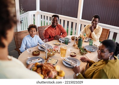 High Angle View Of Happy African American Family At Dinner Table Outdoors With Woman Bringing Homemade Dishes