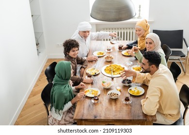 high angle view of happy multiethnic muslim family having dinner at home