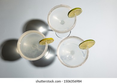 High Angle View Of Homemade Classic Margarita Drink With Lime And Salt On White Table