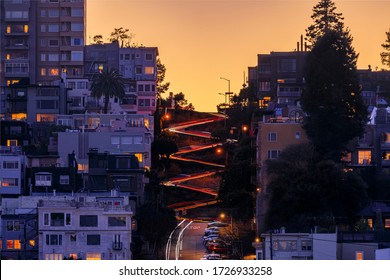 High angle view of illuminated homes on the famous Lombard Street, San Francisco California at sunset, long exposure car light trails and light bursts