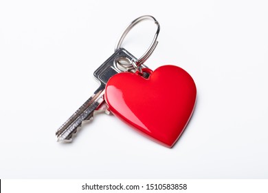High Angle View Of Key With Red Heart Shape Key Chain Over White Background