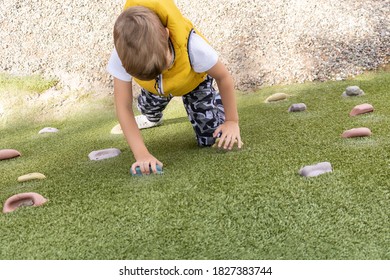 High Angle View Of Kid On Climbing Wall At The Playground. 