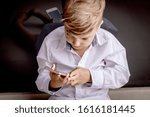 High angle view of kid using smart phone.