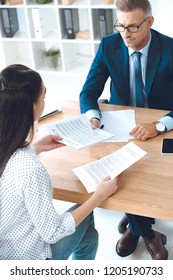 high angle view of lawyer and client discussing contract