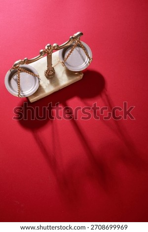 high angle view of libra scale against red background                     