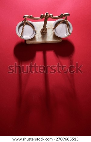 high angle view of libra scale against red background                     