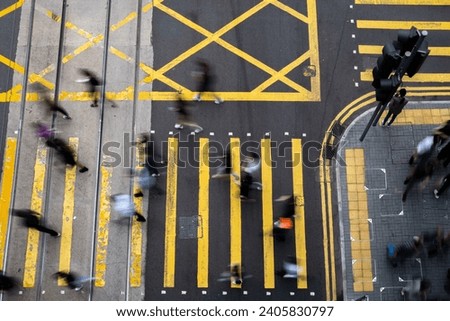 High angle view looking at blurred people crossing the road