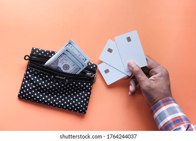 high angle view of man hand holding credit card on orange background 