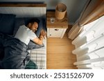 High angle view of a man sleeping in bedroom. Copy space. 