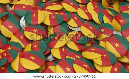 A high angle view of many circular pins showing the Cameroonian flag colors with a yellow star