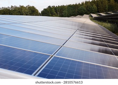 High angle view of massive rows of photovoltaic solar panels on a hillside power station