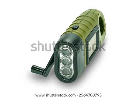 High angle view of mini solar cranking LED flashlight isolated on white background with clipping path. This device charge battery by solar cells or  turning dynamo handle.