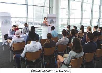 High Angle View Of Mixed-race Businesswoman Speaking In Front Of Business People Sitting At Seminar In Office Building