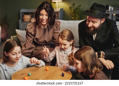 High Angle View At Modern Jewish Family Playing Traditional Dreidel Game In Cozy Home Setting