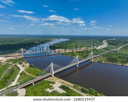 High angle view of the modern Murom Bridge with its cable-stayed design crossing the wide Oka River under a clear sky.