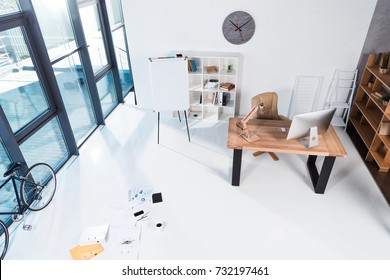 High Angle View Of Modern Office Interior With Documents And Digital Devices