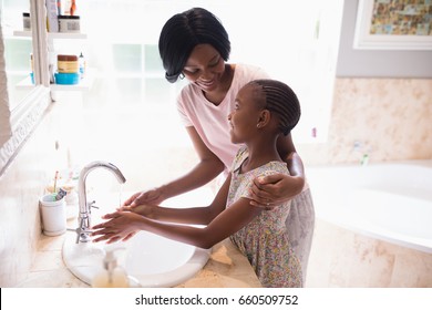 High Angle View Of Mother And Daughter Washing Hands At Sink In Bathroom, Coronavirus Hand Washing For Clean Hands Hygiene Covid19 Spread Prevention.