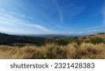 High angle view of mountains, trees, sky.