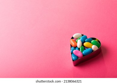 High angle view of multi colored candies in heart shape container by copy space on pink background. unaltered, sweet food and unhealthy eating concept. - Powered by Shutterstock