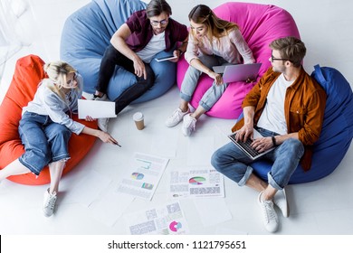 high angle view of multicultural colleagues discussing startup project in office - Powered by Shutterstock