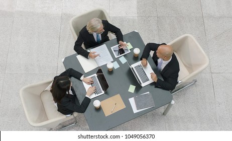 High Angle View Of Multiethnic Corporate Executives Meeting Discussing Business In Office.