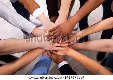 High Angle View Of Multiracial Friend Stacking Hand Together