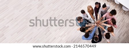High Angle View Of Multiracial Friend Stacking Hand Together