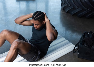 high angle view of muscular african american man doing abs in gym - Powered by Shutterstock