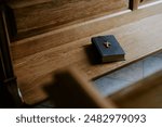 High angle view no people shot of Bible book with cross on wooden pew in Catholic church