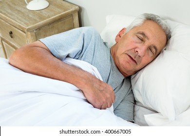 High Angle View Of Old Man Sleeping On Bed At Home