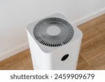 High angle view on household air purifier at modern apartment. Electronic humidifier for moisture and ionizing at home. Climate control appliance. Allergens cleaner indoors concept