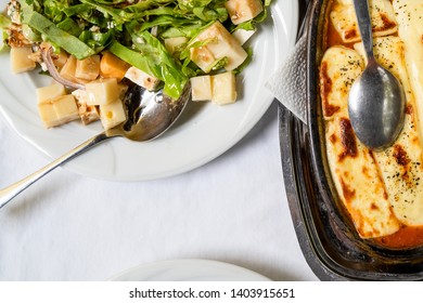 High Angle View On Zucchini Courgette Summer Squash Salad And Baked Cheese On White Plate On The Table