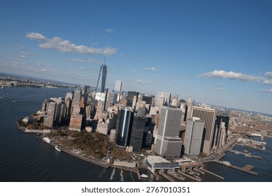High angle view of One World Trade Center in city by river on sunny day