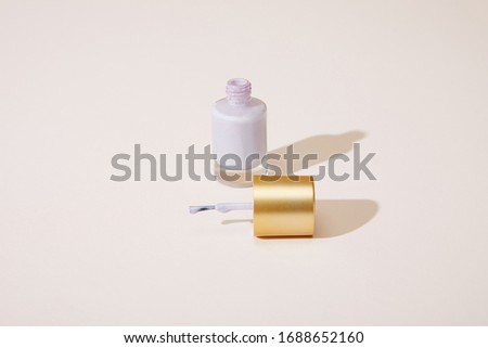 High angle view of opened bottle of nail polish on white