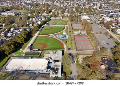 A High Angle View Over An Empty Grant Park With Basketball Courts, Tennis Courts & Colorful Baseball Fields. It Is A Sunny Day And There Are No People In Sight.