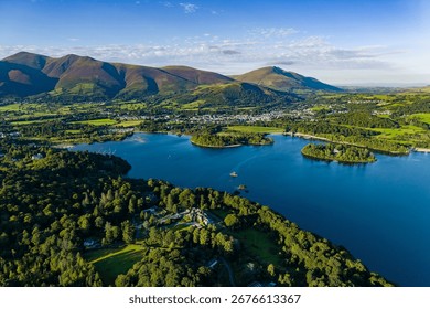 High angle view over lush forest towards Keswick and the Skiddaw mountain range.
